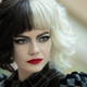 Emma Stone with a black-and-white hairdo as a young Cruella de Vil in Disney's new origin story Cruella.